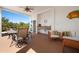 Open patio with outdoor seating, a ceiling fan, and a wet bar setup, great for entertaining at 6802 68Th E Ave, Bradenton, FL 34203