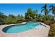 Inviting backyard pool with brick paver deck, surrounded by lush tropical landscaping for privacy at 6802 68Th E Ave, Bradenton, FL 34203
