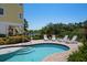Backyard pool area with brick patio and lounge seating overlooking nature at 6802 68Th E Ave, Bradenton, FL 34203