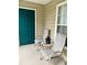 Cozy porch with seating area featuring two chairs, a small table, and a window view at 7411 Vista Way # 102, Bradenton, FL 34202