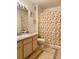 Bathroom with vanity, tiled floors, seashell shower curtain, and neutral wall color at 7411 Vista Way # 102, Bradenton, FL 34202