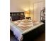 Bedroom with black bed frame, quilt, neutral walls, and a closet door at 7411 Vista Way # 102, Bradenton, FL 34202