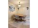 Dining area with a round wooden table, four rolling chairs and tile flooring at 7411 Vista Way # 102, Bradenton, FL 34202