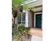 Charming covered entryway with green door, landscaping, and address number 102 at 7411 Vista Way # 102, Bradenton, FL 34202