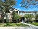 Inviting two-story home with lush landscaping, palm trees, and a clearly marked address at 7411 Vista Way # 102, Bradenton, FL 34202