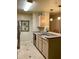 Kitchen features stainless appliances, a tile floor, and a stainless steel, double basin sink at 7411 Vista Way # 102, Bradenton, FL 34202