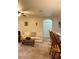Bright living room with cream-colored sofa, archway, ceiling fan, and neutral carpet at 7411 Vista Way # 102, Bradenton, FL 34202