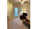 Cozy living room with neutral carpeting, a ceiling fan and an exit to the porch at 7411 Vista Way # 102, Bradenton, FL 34202
