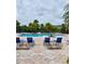 Inviting pool area with blue lounge chairs and tables for relaxing poolside at 7411 Vista Way # 102, Bradenton, FL 34202