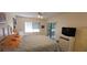 Bedroom features a bed, a TV on a dresser, and sliding glass door to screened balcony at 7858 Eagle Creek Dr # 7442, Sarasota, FL 34243