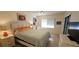 Bright and airy bedroom featuring neutral colors, a bed, and a sitting area at 7858 Eagle Creek Dr # 7442, Sarasota, FL 34243