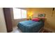 Cozy bedroom with a large window, a comfortable bed, and warm lighting at 7858 Eagle Creek Dr # 7442, Sarasota, FL 34243