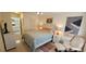 Bedroom featuring a bed, a sitting chair, and an adjoining bathroom at 7858 Eagle Creek Dr # 7442, Sarasota, FL 34243