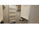 Organized walk-in closet providing ample storage with shelves and hanging space at 7858 Eagle Creek Dr # 7442, Sarasota, FL 34243