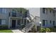 Condo featuring stairs to an upper level unit, with a palm tree in the front at 7858 Eagle Creek Dr # 7442, Sarasota, FL 34243