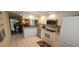Modern kitchen with white appliances and view to the combined living and dining area at 7858 Eagle Creek Dr # 7442, Sarasota, FL 34243