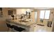 Bright kitchen with a breakfast bar, granite countertops and white cabinets at 7858 Eagle Creek Dr # 7442, Sarasota, FL 34243