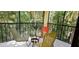 Cozy screened patio with a round table, chairs, and a garden view at 7858 Eagle Creek Dr # 7442, Sarasota, FL 34243