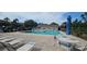 Community pool with lounge chairs and umbrellas offering a refreshing space to relax in at 7858 Eagle Creek Dr # 7442, Sarasota, FL 34243