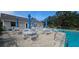 Community pool with tables and chairs and umbrellas offering a refreshing space to relax in at 7858 Eagle Creek Dr # 7442, Sarasota, FL 34243