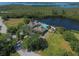 Stunning aerial view of a community clubhouse and pool with lush landscaping and tranquil water views at 79 Tidy Island Blvd, Bradenton, FL 34210