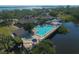 Expansive community aerial view showcases the pool, clubhouse, and serene waterfront location at 79 Tidy Island Blvd, Bradenton, FL 34210