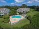 An aerial view showcasing the backyard pool, patio, and home's setting at 79 Tidy Island Blvd, Bradenton, FL 34210