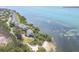 Stunning aerial view of waterfront home with private beach access and lush landscaping at 79 Tidy Island Blvd, Bradenton, FL 34210