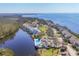 Scenic aerial view of waterfront homes and community pool, nestled along a tranquil waterway with ocean access at 79 Tidy Island Blvd, Bradenton, FL 34210