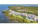 Stunning aerial view of several waterfront homes, lush greenery, and tranquil bay at 79 Tidy Island Blvd, Bradenton, FL 34210