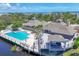 Aerial view of a community pool, cabana, and seating area overlooking the water at 79 Tidy Island Blvd, Bradenton, FL 34210