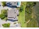 An aerial view showcasing the home's layout, proximity to the water, and lush landscaping at 79 Tidy Island Blvd, Bradenton, FL 34210
