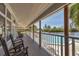 Inviting balcony with comfortable seating and a beautiful view of the pool and waterfront at 79 Tidy Island Blvd, Bradenton, FL 34210