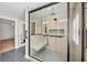 Modern bathroom featuring a glass shower with a built-in seat and gray and white mosaic tile floor at 79 Tidy Island Blvd, Bradenton, FL 34210