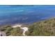 Private beach aerial view showcasing beach chairs, lush plants, and tranquil ocean views at 79 Tidy Island Blvd, Bradenton, FL 34210