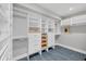 Spacious walk-in closet with custom built-in shelves, drawers, and blue tile flooring for organization at 79 Tidy Island Blvd, Bradenton, FL 34210