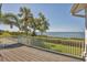Waterfront deck with white railings and tropical trees offers stunning views of the bay at 79 Tidy Island Blvd, Bradenton, FL 34210