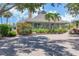 Beautiful clubhouse with lush landscaping, stone walkway, and ample natural light at 79 Tidy Island Blvd, Bradenton, FL 34210