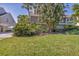 Beautiful home exterior showcasing lush landscaping, palm trees, and well-manicured lawn at 79 Tidy Island Blvd, Bradenton, FL 34210