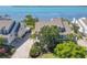 View of a well-maintained two-story home with mature palms and long driveway at 79 Tidy Island Blvd, Bradenton, FL 34210