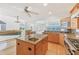 Modern kitchen features a granite island, stainless steel appliances, and an open design to the living area at 79 Tidy Island Blvd, Bradenton, FL 34210