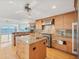 Spacious kitchen with granite counters, stainless appliances, and center island overlooking water views at 79 Tidy Island Blvd, Bradenton, FL 34210