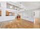 Bright and airy living room with vaulted ceilings, wood floors and built-in shelves, and a view to the kitchen at 79 Tidy Island Blvd, Bradenton, FL 34210