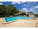 Community pool area with comfortable chairs surrounded by mature landscaping at 79 Tidy Island Blvd, Bradenton, FL 34210