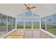Bright sunroom with floor-to-ceiling windows showcasing beautiful water views at 79 Tidy Island Blvd, Bradenton, FL 34210