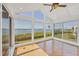 Bright sunroom with floor-to-ceiling windows showcase expansive water views at 79 Tidy Island Blvd, Bradenton, FL 34210