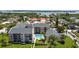 Aerial view of condominium complex with pool, green spaces, and water views at 845 Benjamin Franklin Dr # 101, Sarasota, FL 34236