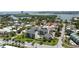 Exterior aerial view of an apartment complex with lush landscaping, a pool, and coastal views in Florida at 845 Benjamin Franklin Dr # 101, Sarasota, FL 34236