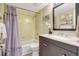 Updated bathroom with granite vanity, shower, bathtub, and decorative accents at 845 Benjamin Franklin Dr # 101, Sarasota, FL 34236