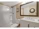 Bright bathroom featuring a walk-in shower, a white vanity, and a framed mirror at 845 Benjamin Franklin Dr # 101, Sarasota, FL 34236